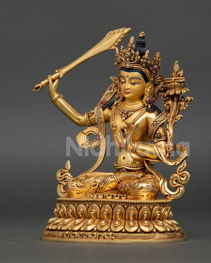 Left side view of Manjushri statue with flowing robe and scripture