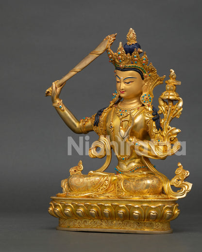left side view of manjushri wisdom deity statue with scripture lotus and crown