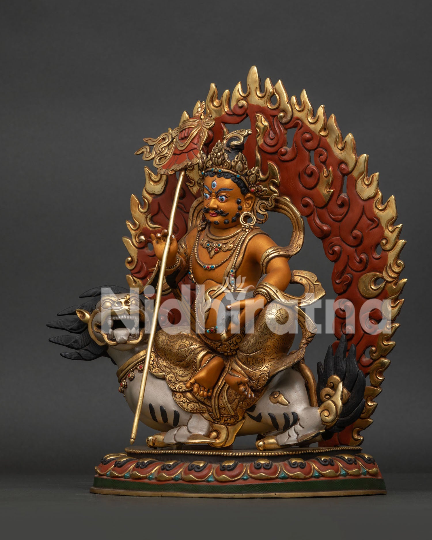 Left side view of Namtoshe Vaishravana statue holding sacred jewel-spouting mongoose