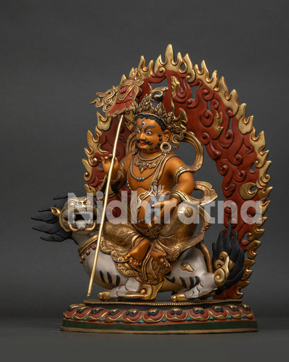 Left side view of Namtoshe Vaishravana statue holding sacred jewel-spouting mongoose