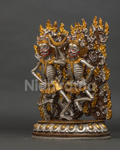Left side view of Nepalese Citipati skeleton statue with gold and silver details