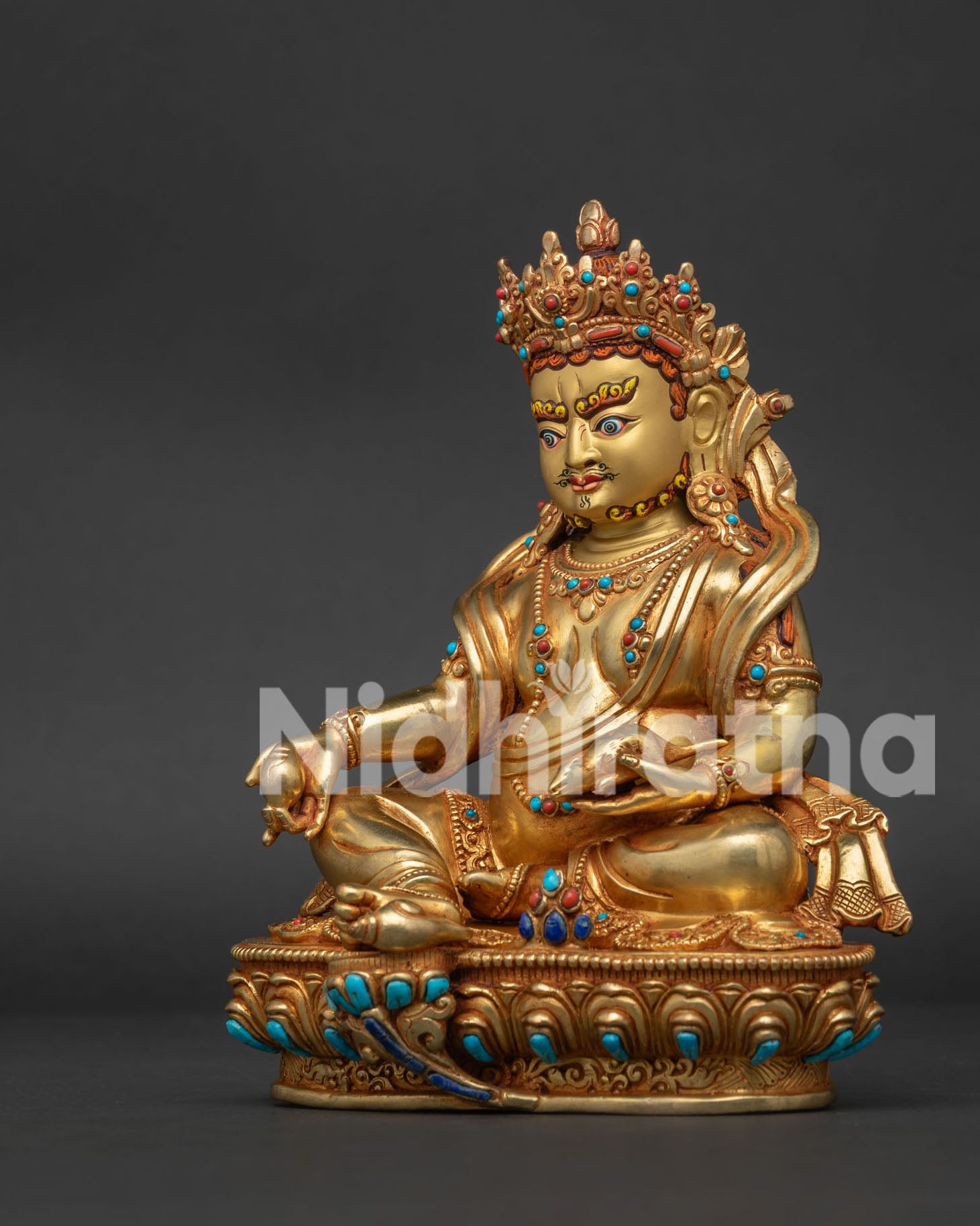 left side view of Nepalese Dzambhala statue with gold gilded ornaments