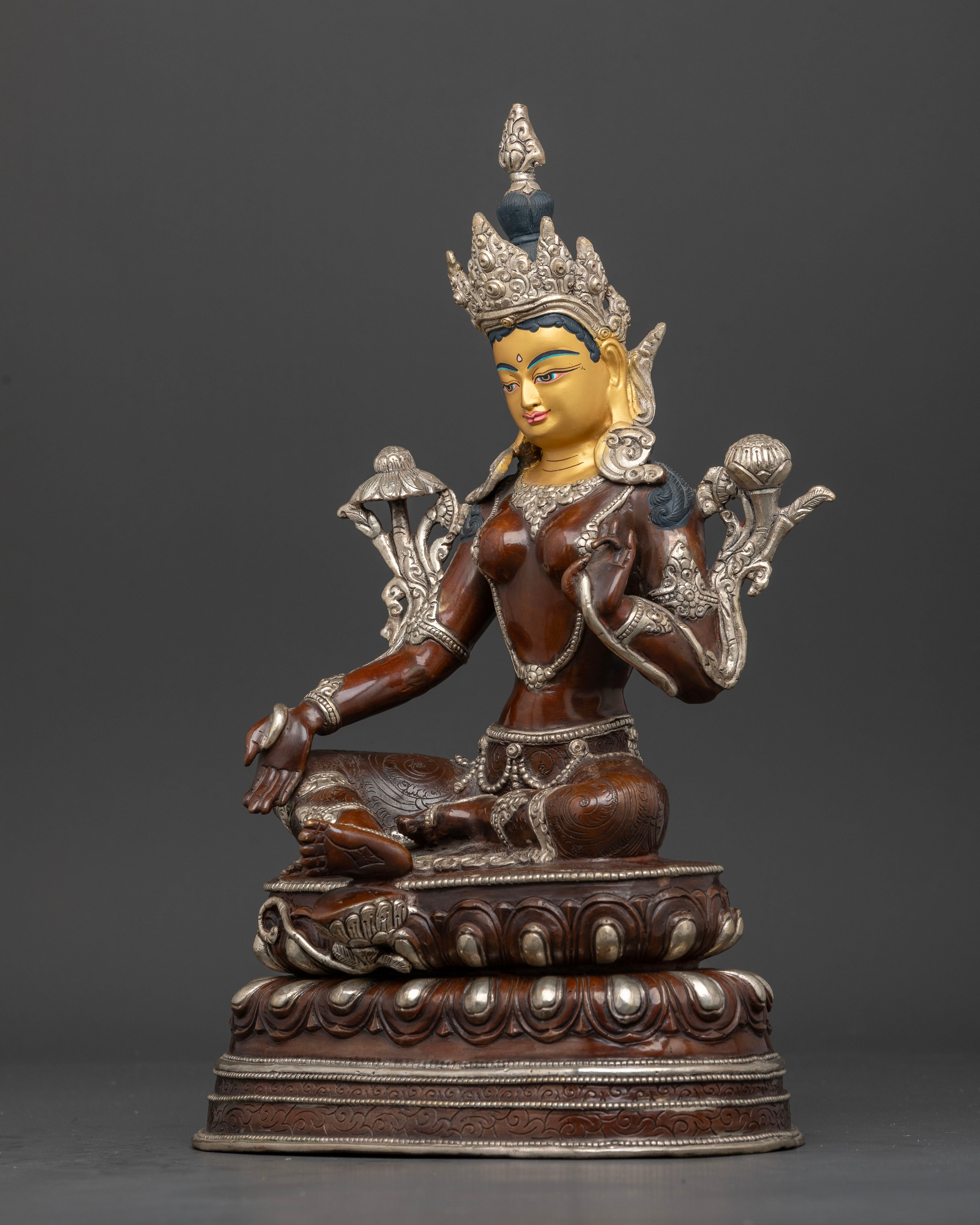 Left side view of Nepalese Green Tara copper sculpture showing posture and floral patterns.