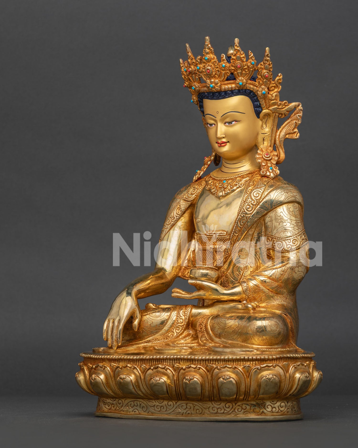 Left side view of Nepalese Shakyamuni Buddha statue with gold gilded details

