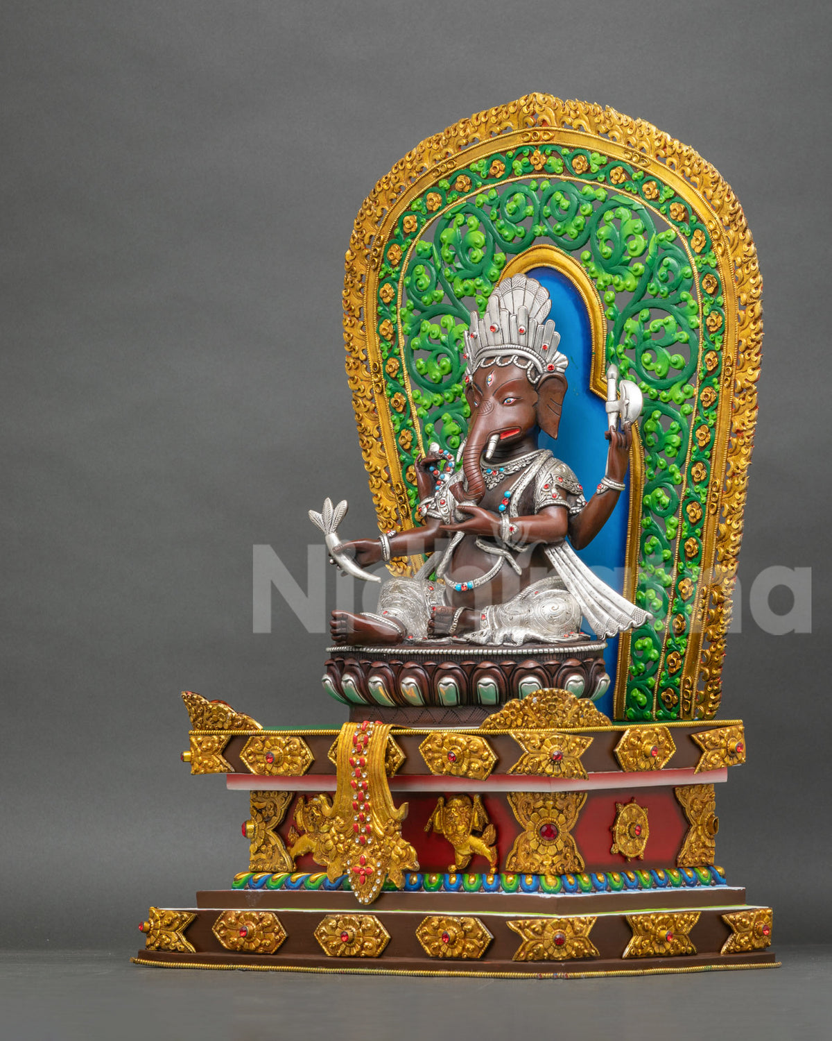 Left side view of Newari Ganesh idol on vibrant lion throne, oxidized copper and gold gilded art