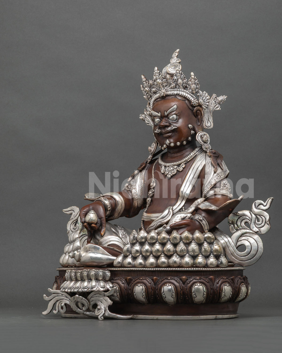 Left side view of oxidized copper Dzambhala statue with jewel-spitting mongoose