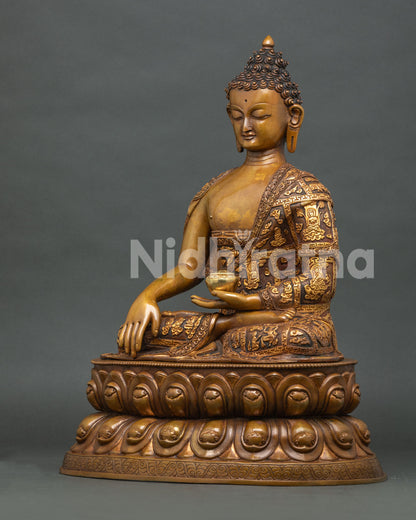 Left side view of oxidized copper Shakyamuni Buddha statue in earth touching mudra on lotus throne