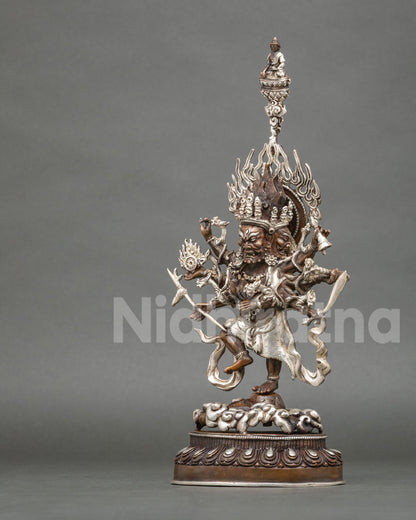 Left side view of oxidized copper Ucchusma statue standing on a lotus pedestal with silver detailing