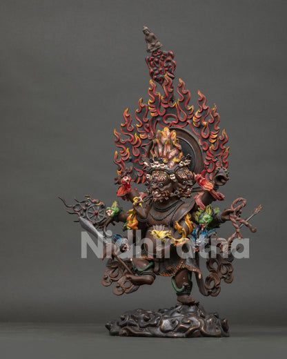 Left side view of Oxidized Copper Ucchusma Statue with tiger skin garment and ritual implements