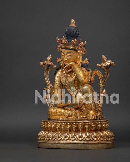 Left side view of Padmapani Lokeshvara copper statue with lotus flower.
