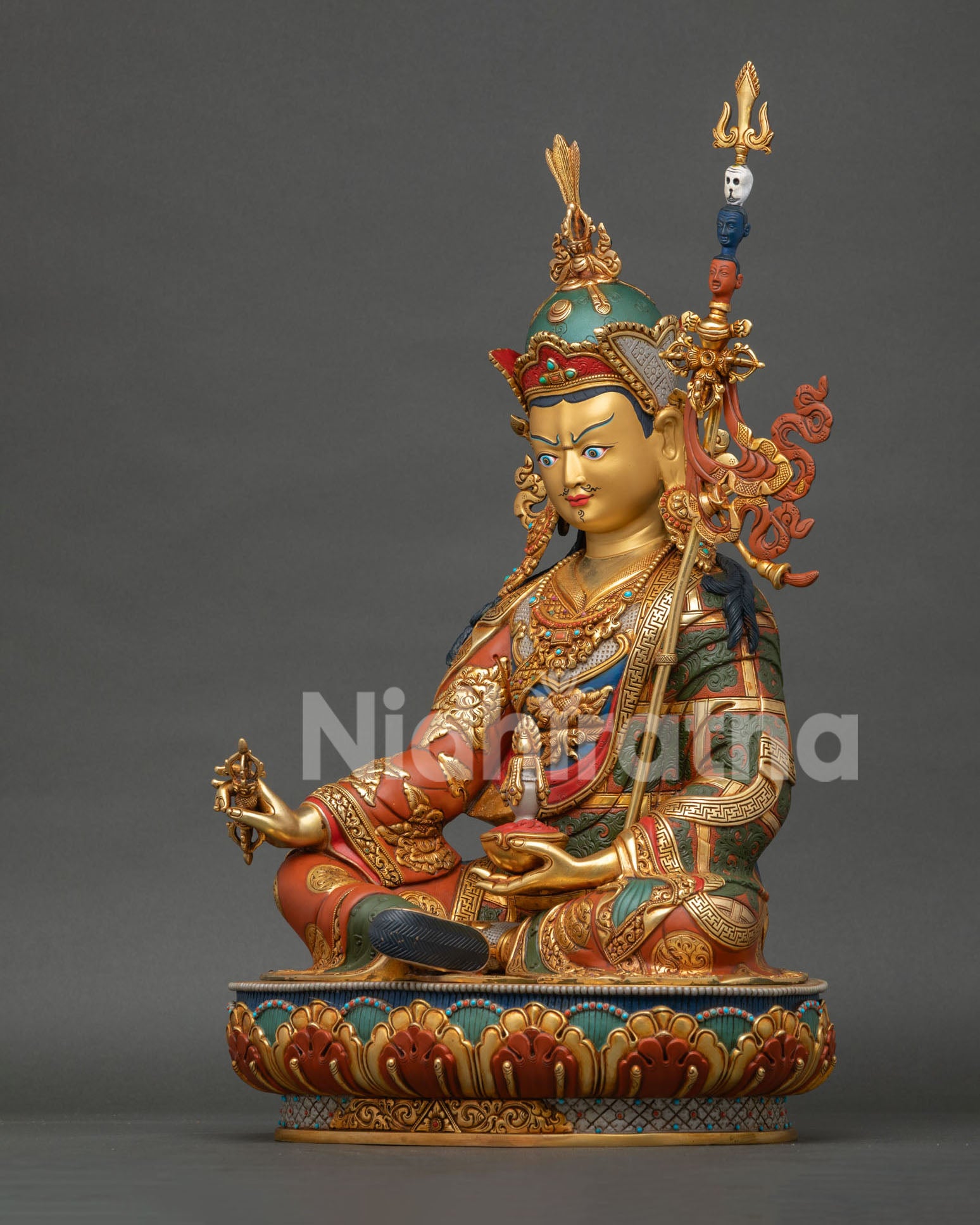 Left side view of Padmasambhava Statue featuring traditional robes and sacred Buddhist symbolism