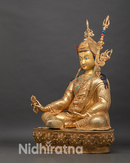 Left side view of Padmasambhava statue with ornate robes turquoise coral inlaid details