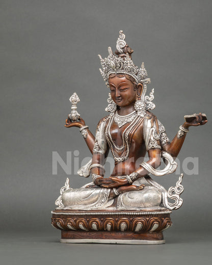 Left side view of Prajnaparamita statue holding a sutra, oxidized copper with silver details