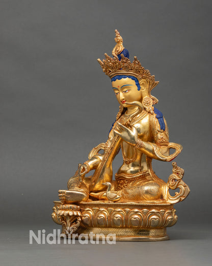 Left side view of Saraswati statue seated on lotus, traditional Hindu goddess art