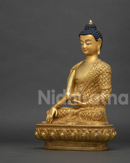 Left side view of Shakyamuni Buddha statue holding begging bowl, gold fire-gilded copper