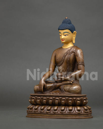 Left side view of Shakyamuni Buddha statue holding begging bowl, oxidized copper with silver-plating