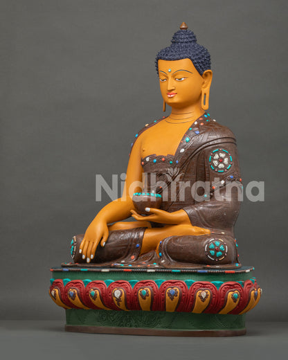 Left side view of Shakyamuni Buddha statue with begging bowl and oxidized engraved finish