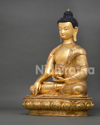 Left side view of Shakyamuni Buddha statue with traditional Buddhist sculptural details
