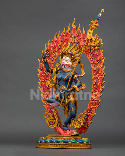 left side view of simhamukha buddhist statue with flowing robes and sacred details