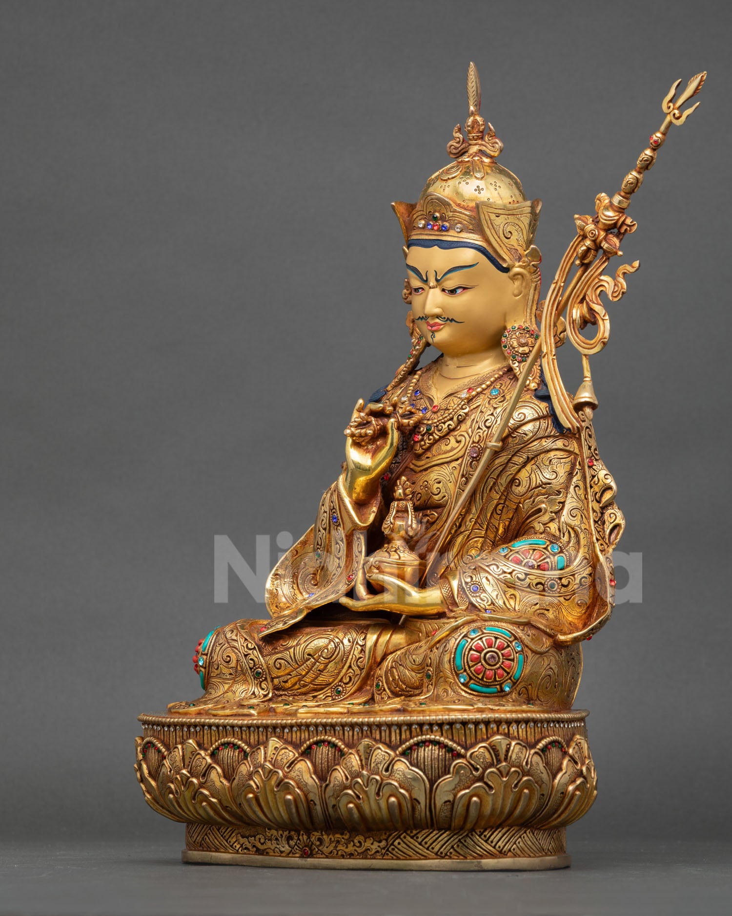 left side view of tsokye dorje statue with vajra and flowing tantric robes