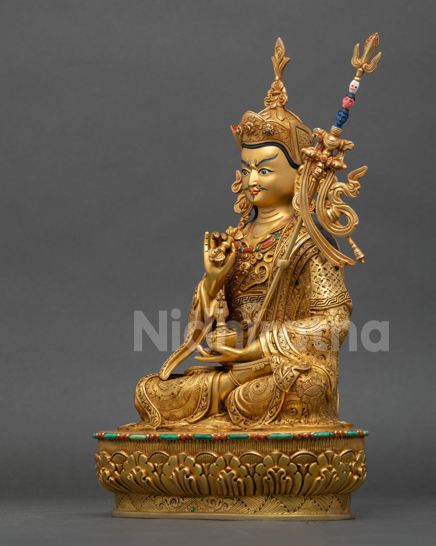 left side view of tsokye dorje vajrayana statue with sacred symbols
