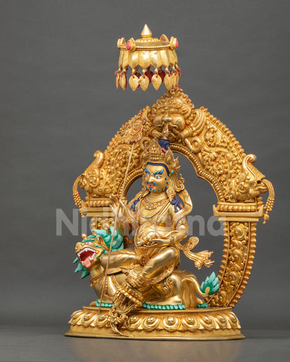Left side view of Vaishravana wealth deity statue holding jewel-spitting mongoose, gold gilded copper