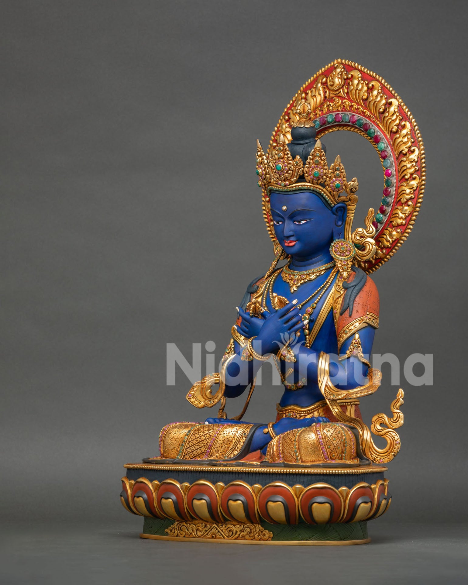 Left side view of Vajradhara Buddha Statue highlighting carved robes and ornaments