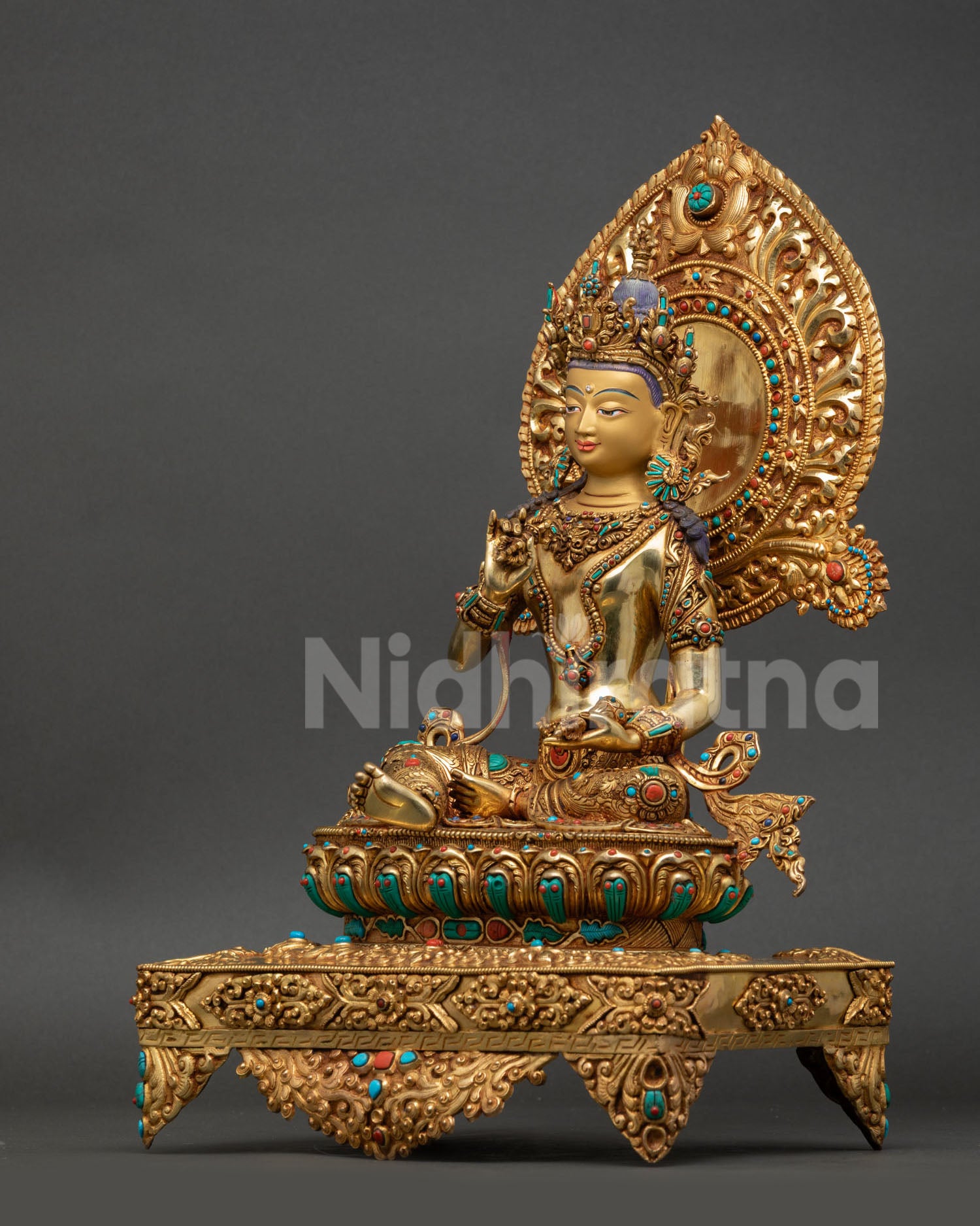 Left side view of Vajrasattva throne statue with ornate lotus base and halo