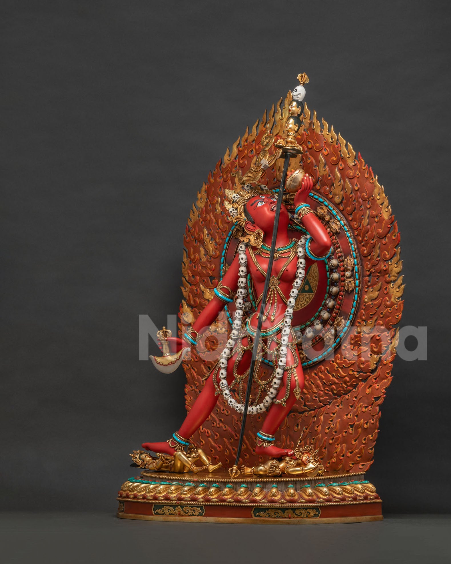 Left side view of Vajrayogini sculpture with flame nimbus and pentagon mandala