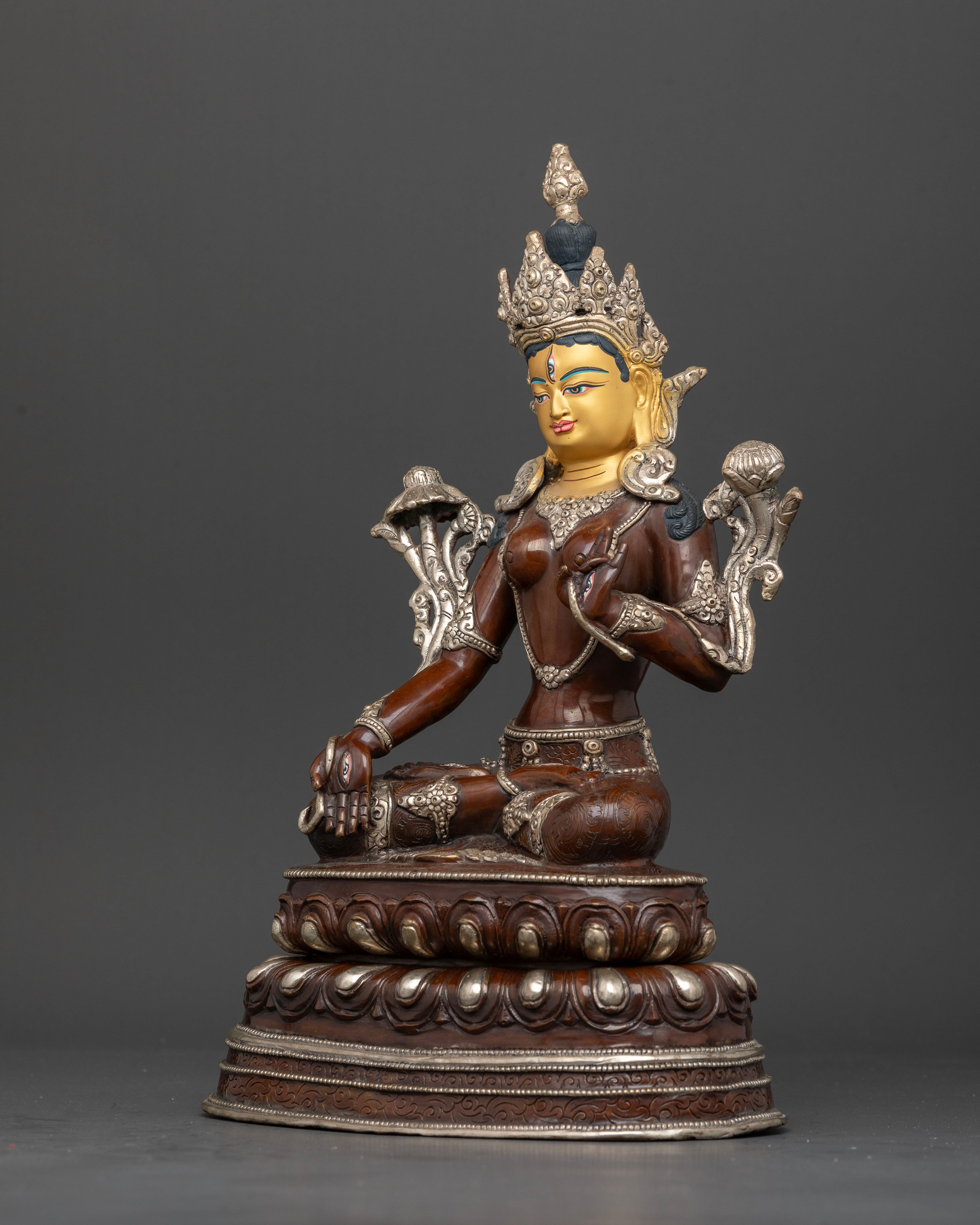 Left side view of White Tara copper idol with lotus seat and flowing robes