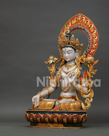 left side view of white tara meditation statue with gold gilded copper details