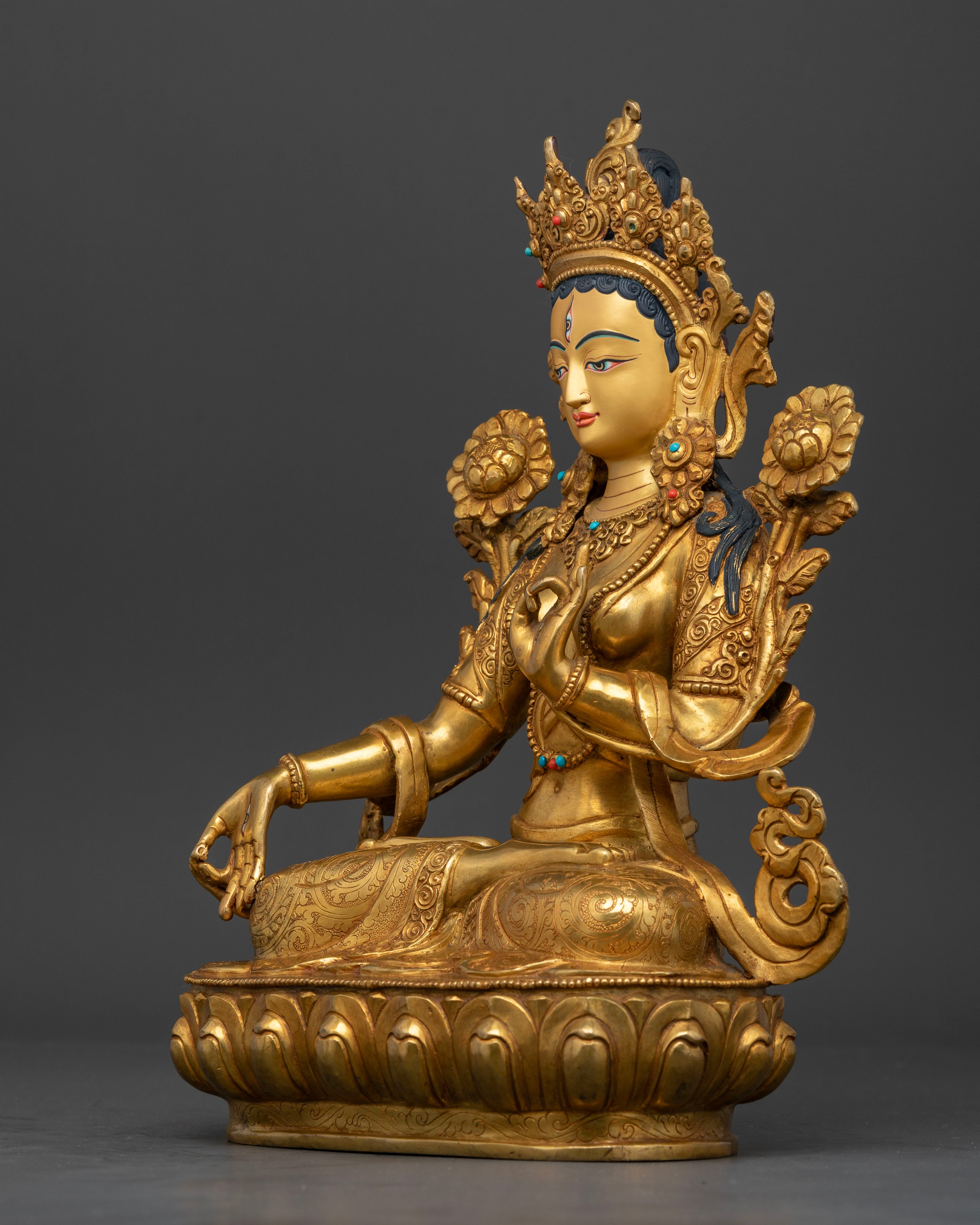 Left side view of White Tara Sculpture with sacred mudras and gemstone details