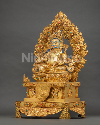 Left side view of Yellow Dzambhala statue on lion-supported throne, fire-gilded copper with gemstone inlay