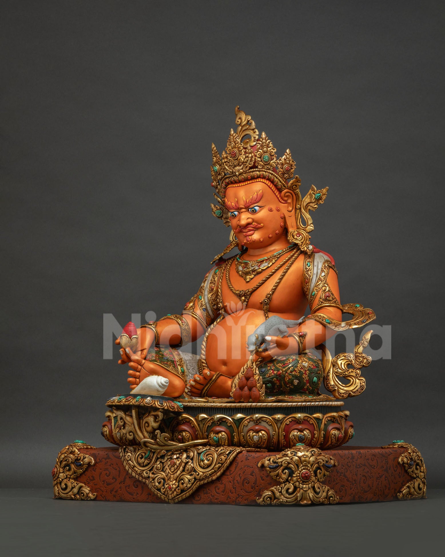 Left side view of Yellow Dzambhala statue with jewel spitting mongoose and repoussé work