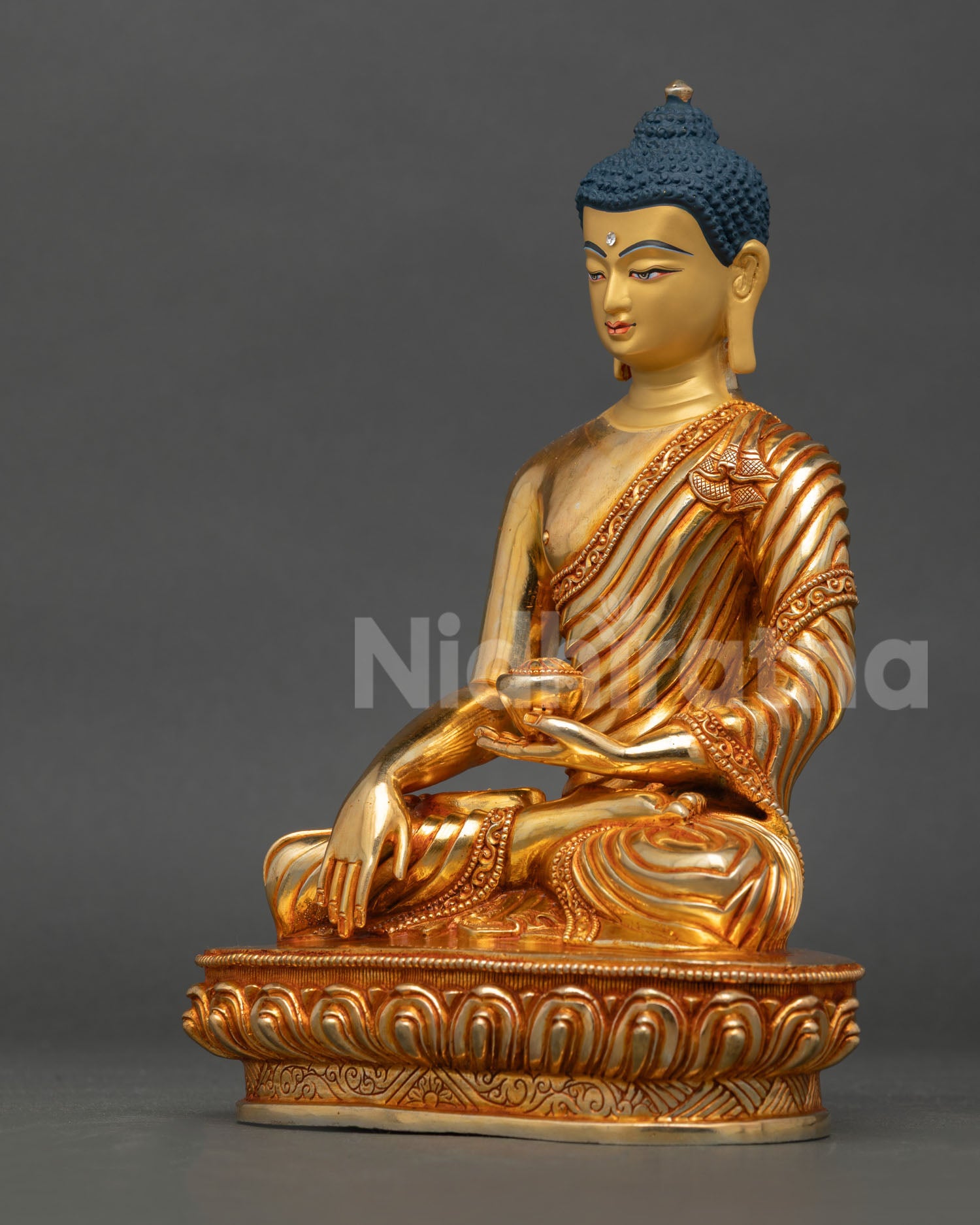 left side view shakyamuni buddha statue, gold gilded details, turquoise accents, nepal statue