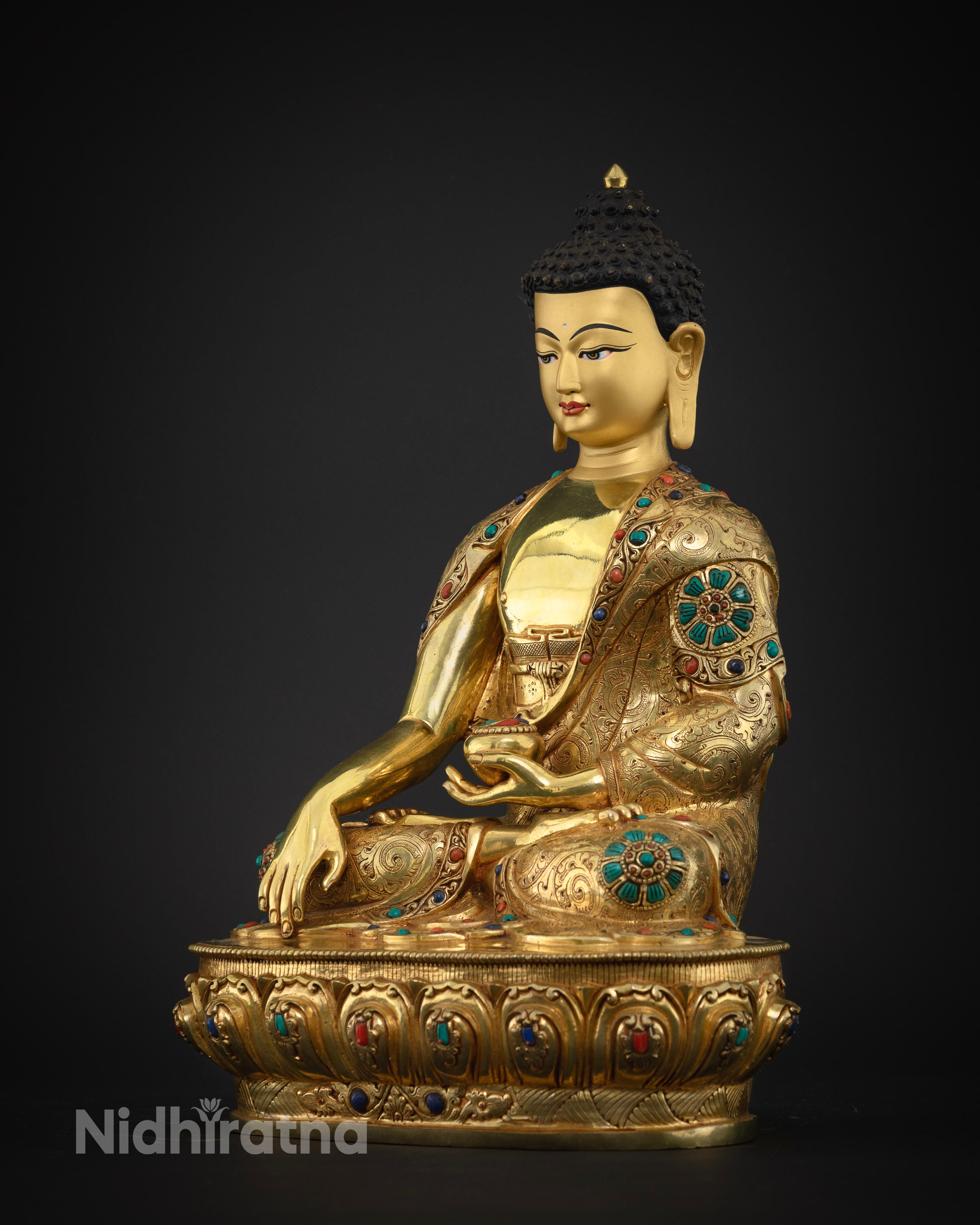Left side view of Shakyamuni Buddha statue with hand-chased floral engravings