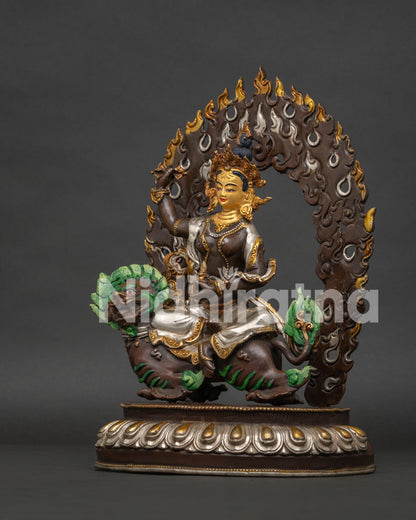 Left side view showing silver-plated detailing on Tsheringma statue