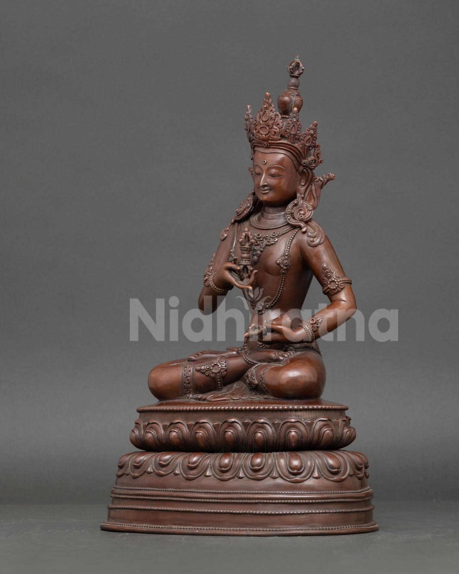 left side view Vajrasattva statue oxidized copper vajra bell iconography Nepal