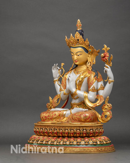 Left view of Chenrezig statue displaying four arms, lotus flower, and traditional Tibetan attire