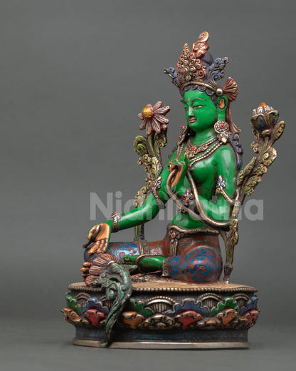 left view of green tara statue handcrafted in nepal with colorful lotus throne