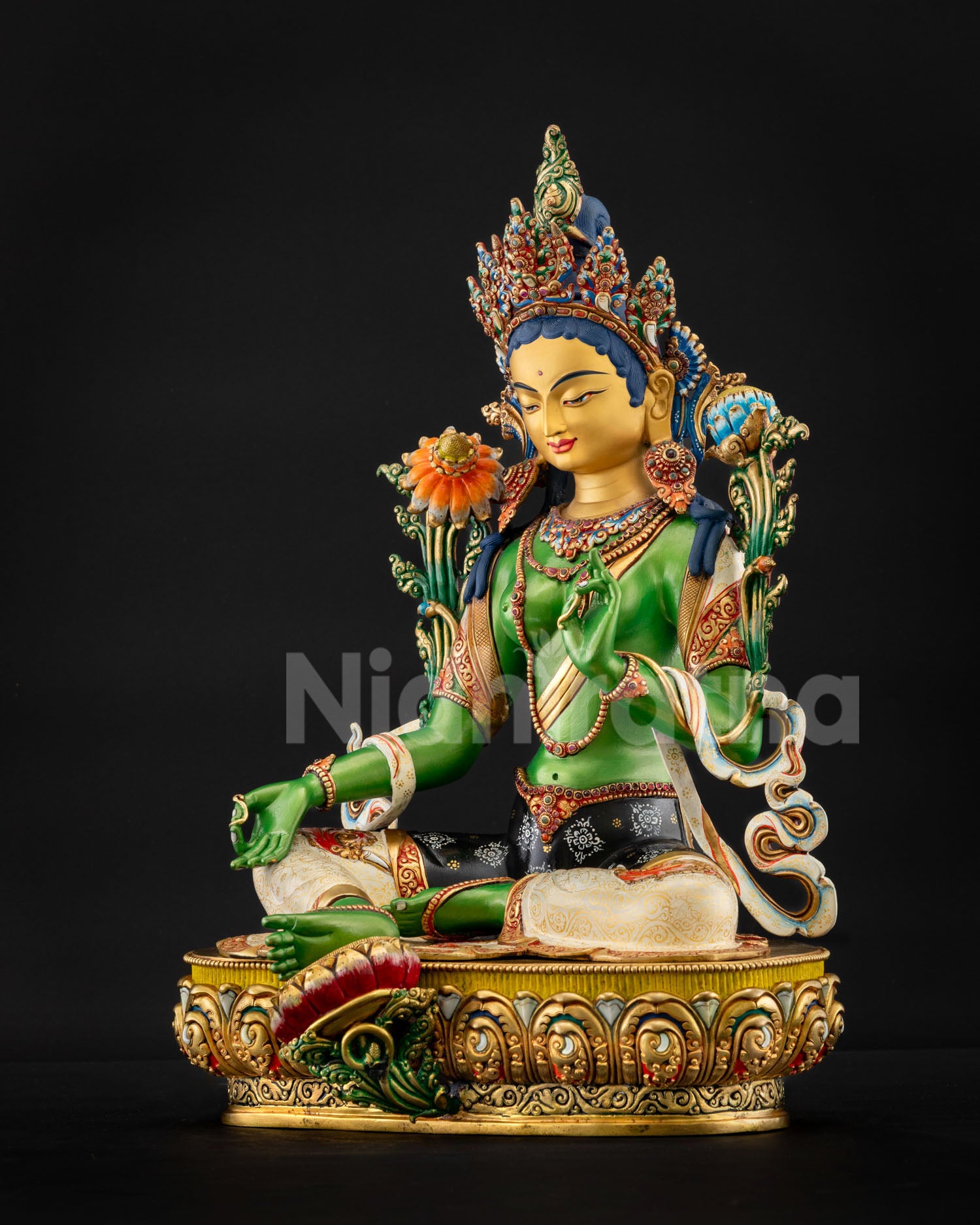 Left view of Green Tara Statue in Lalitasana posture with extended foot on lotus and serene green body radiating compassion
