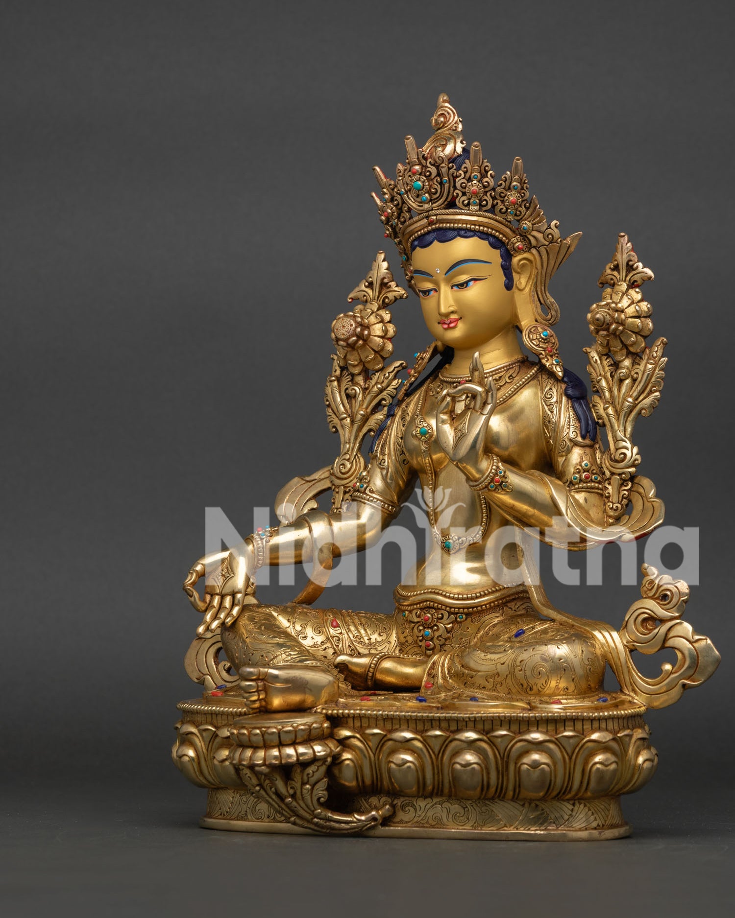 Left view of Green Tara Statue showing intricate robes and Himalayan craftsmanship