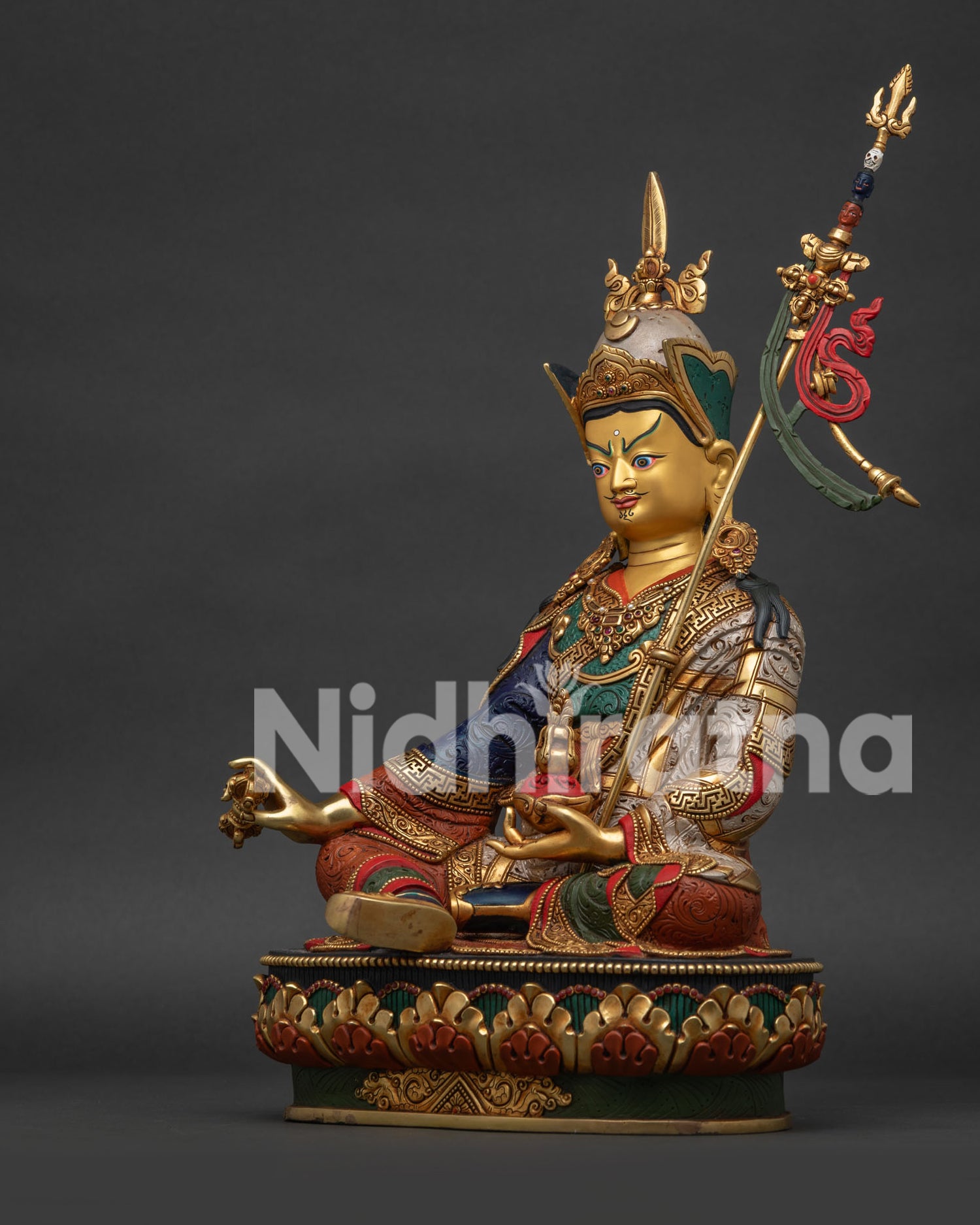 Left view of Guru Rinpoche Statue displaying Vajra Kapala and silver-plated finish