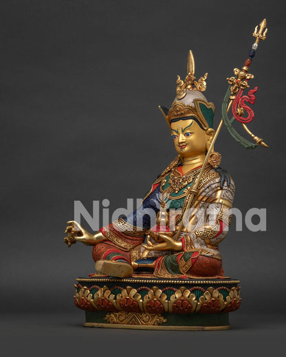 Left view of Guru Rinpoche Statue displaying Vajra Kapala and silver-plated finish