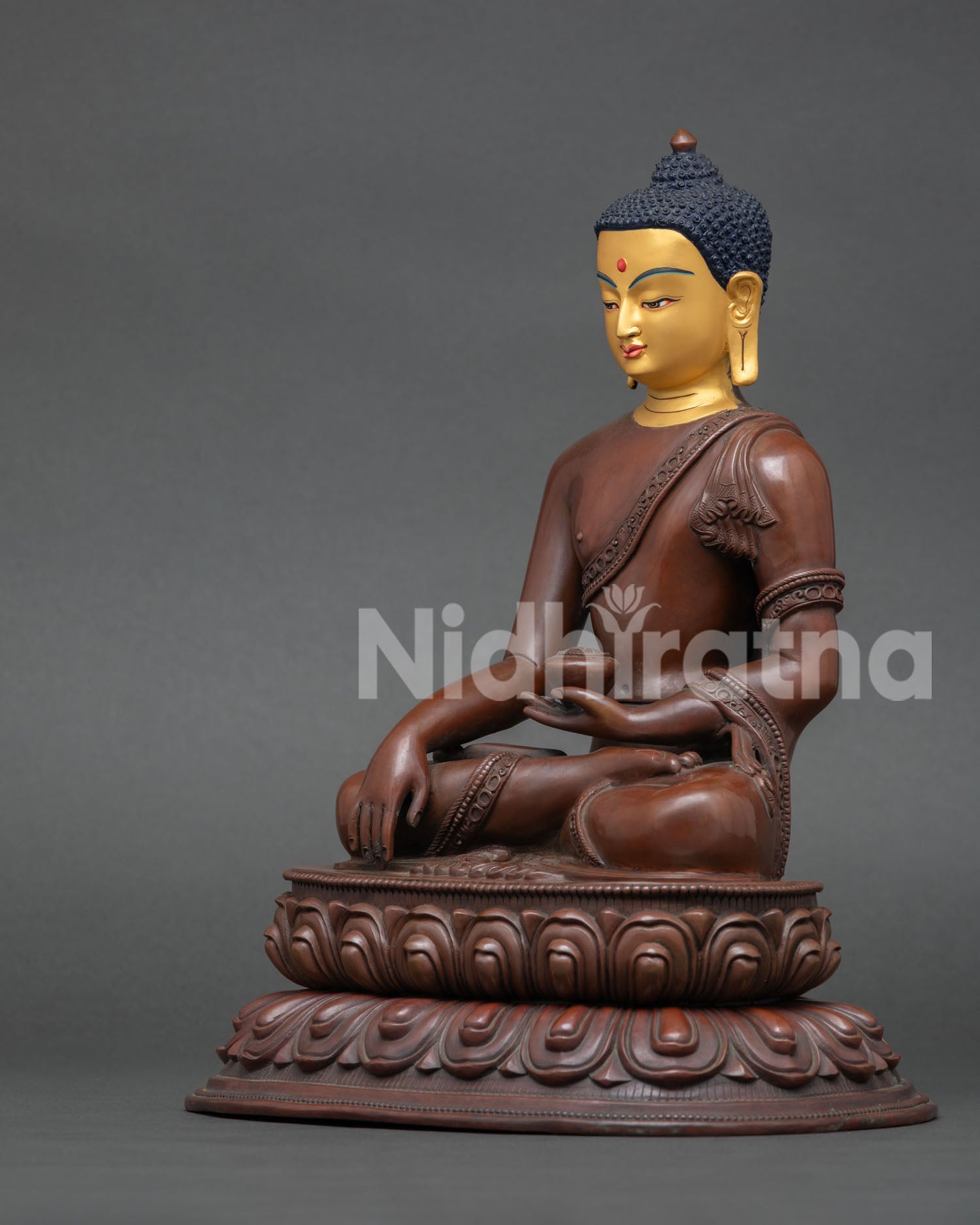 left view of handcrafted shakyamuni buddha statue with oxidized patina
