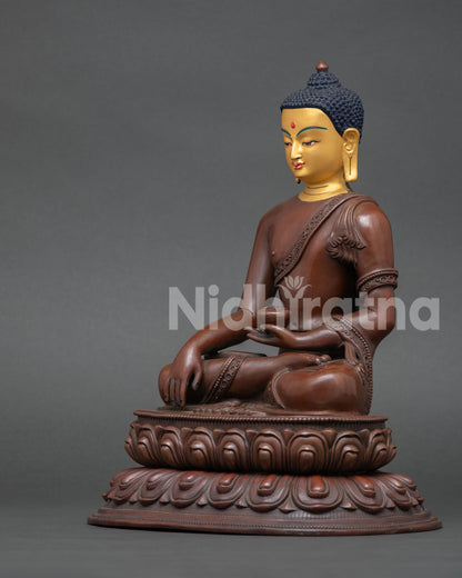 left view of handcrafted shakyamuni buddha statue with oxidized patina