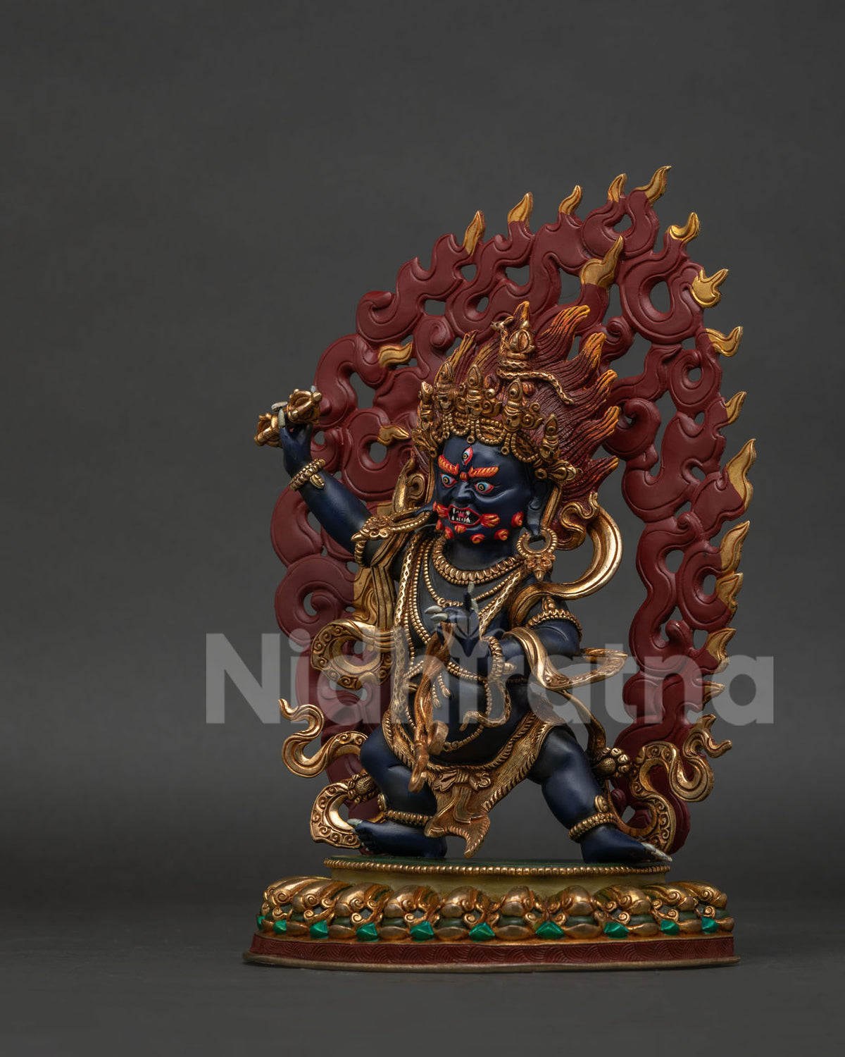 Left view of handcrafted Vajrapani protector holding a vajra and lasso on lotus pedestal.