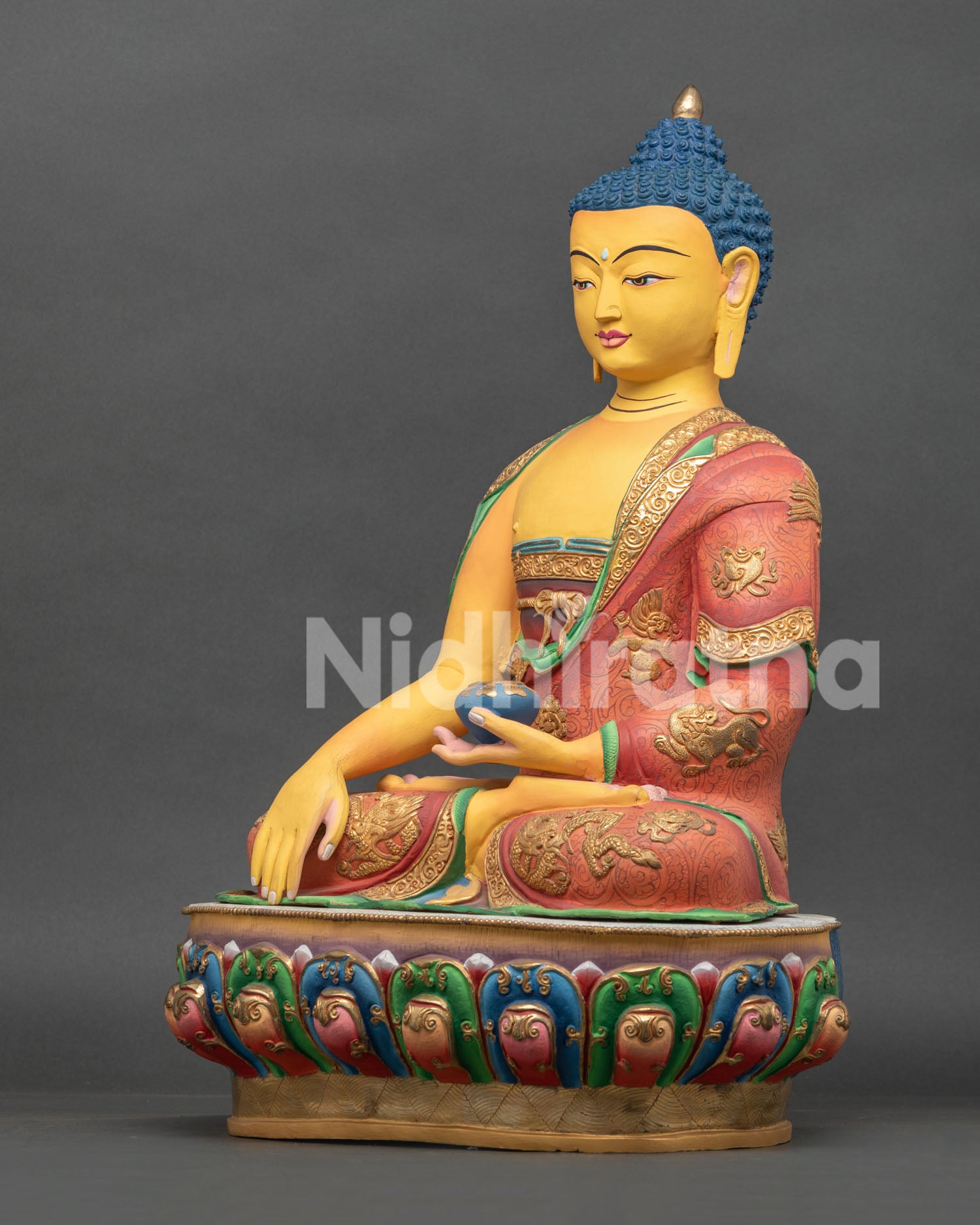 Left view of Nepalese Shakyamuni Buddha Statue with gold gilded robes and sacred Buddhist details
