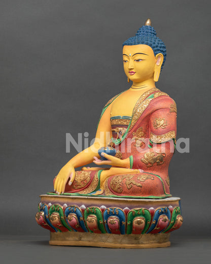 Left view of Nepalese Shakyamuni Buddha Statue with gold gilded robes and sacred Buddhist details