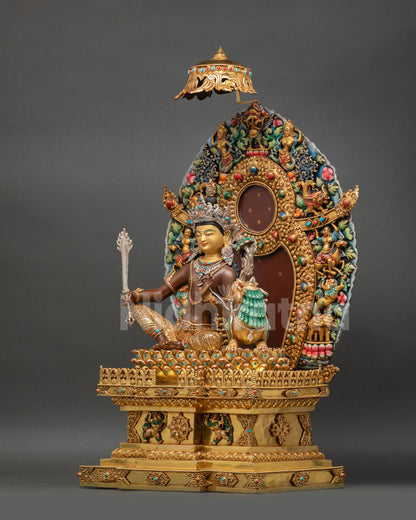 left view of simhanada manjushri statue holding utpala lotus on torana throne
